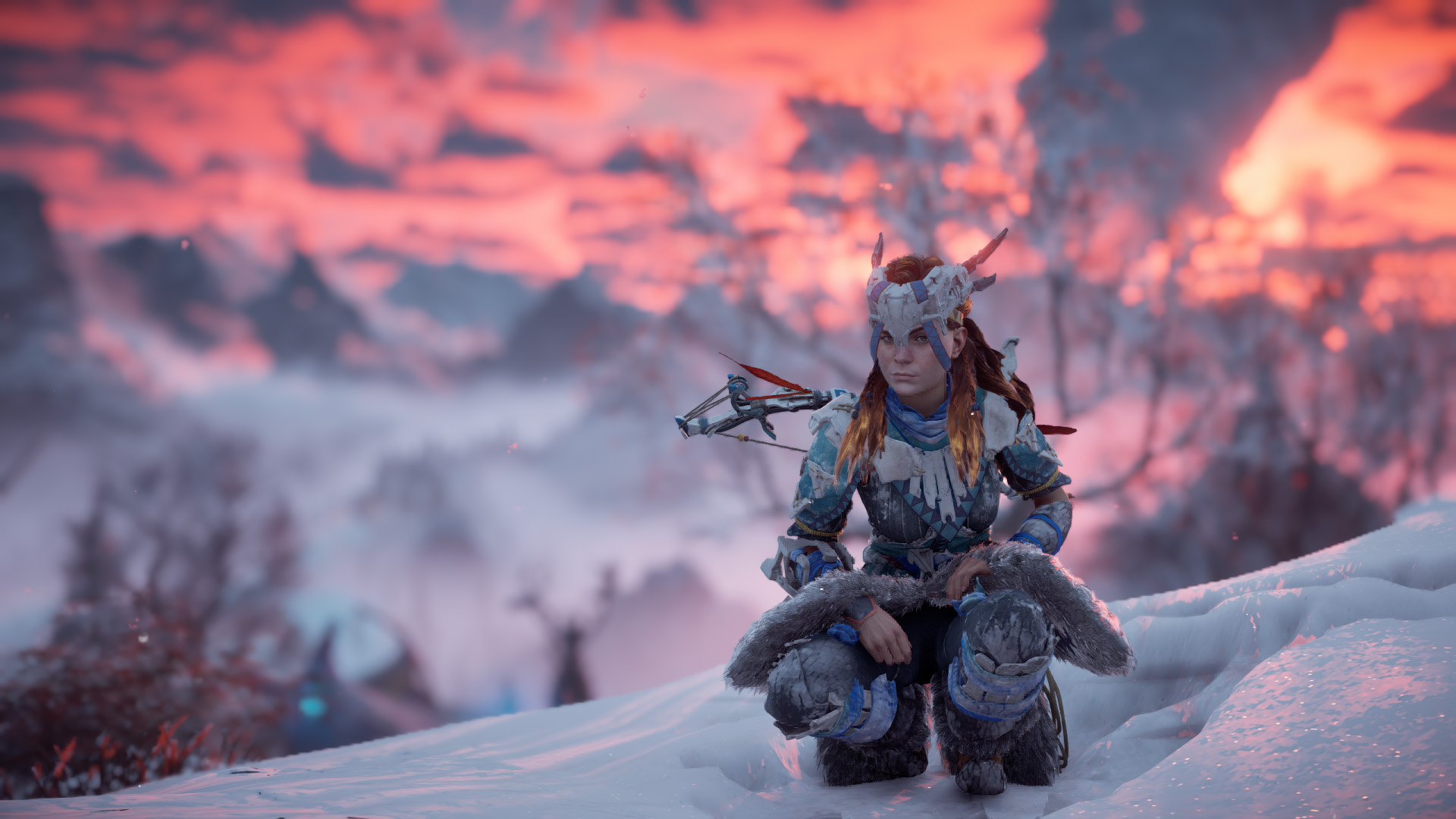 Screenshot of Horizon Zero Dawn. Aloy pauses, crouched in a deep snow drift, with the sun setting like fire in the background.